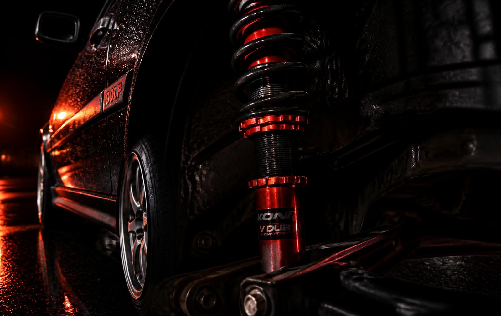 Red performance coilover mounted on a Volkswagen Golf